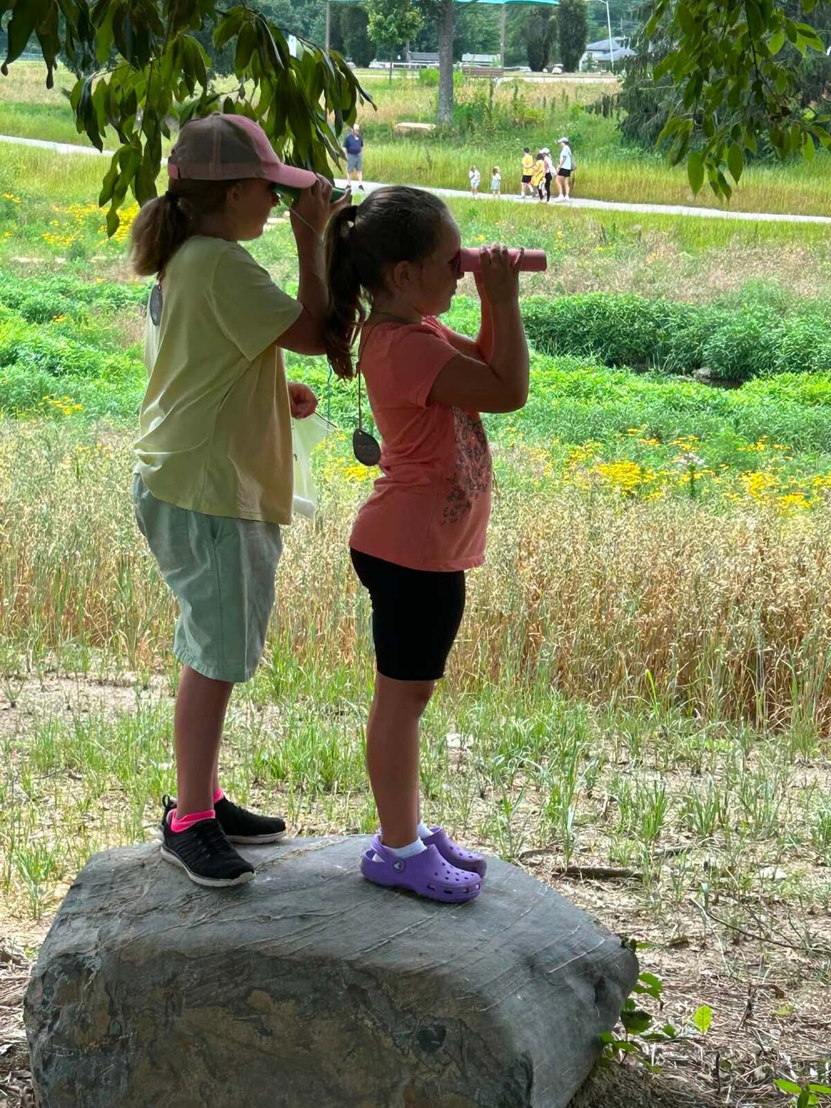 Kids exploring the outdoors with binoculars